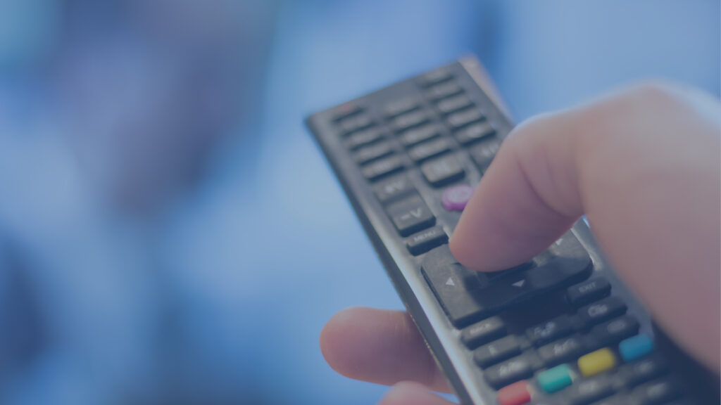 Hand holding a remote.