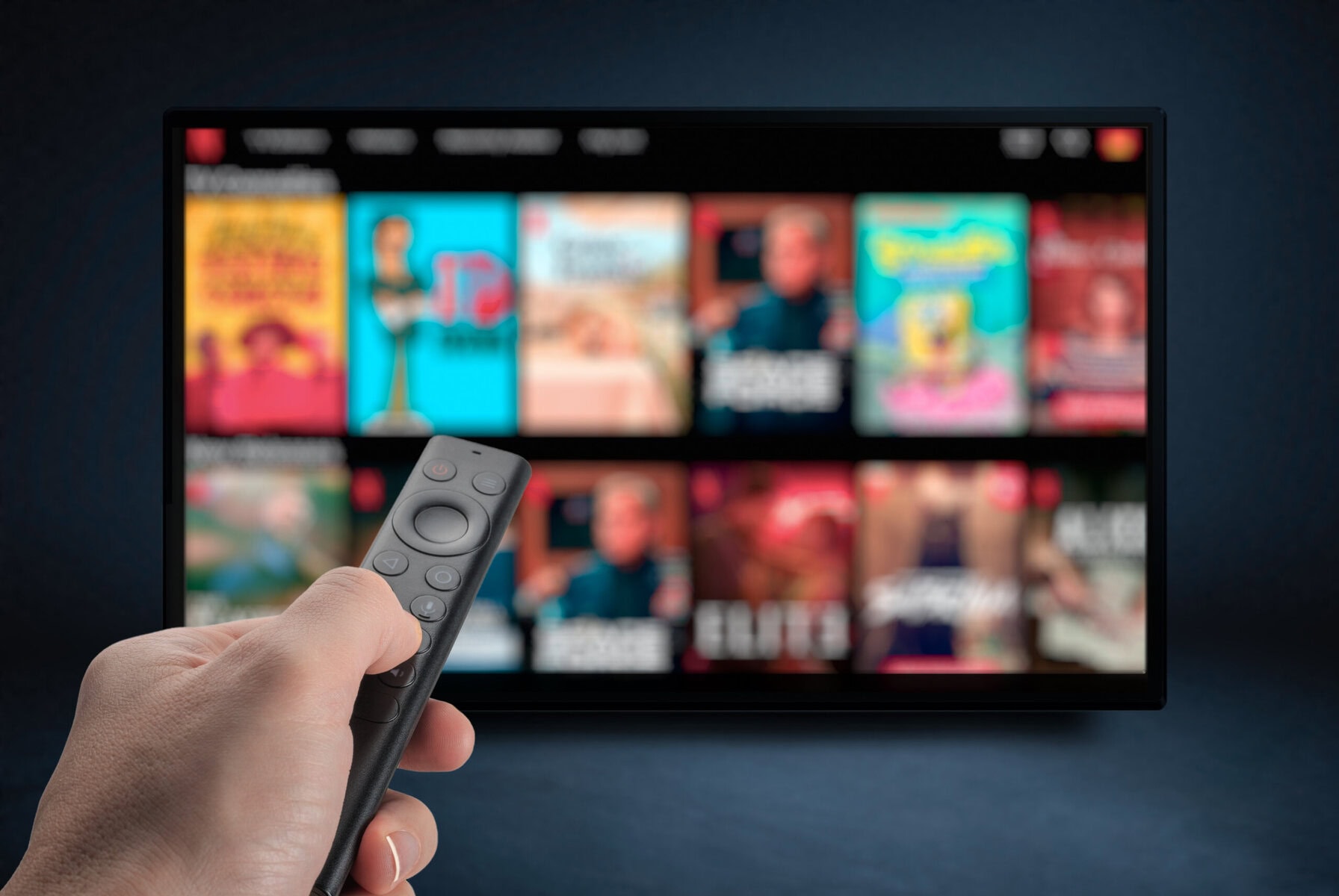 Watching online TV with remote control in hand.
